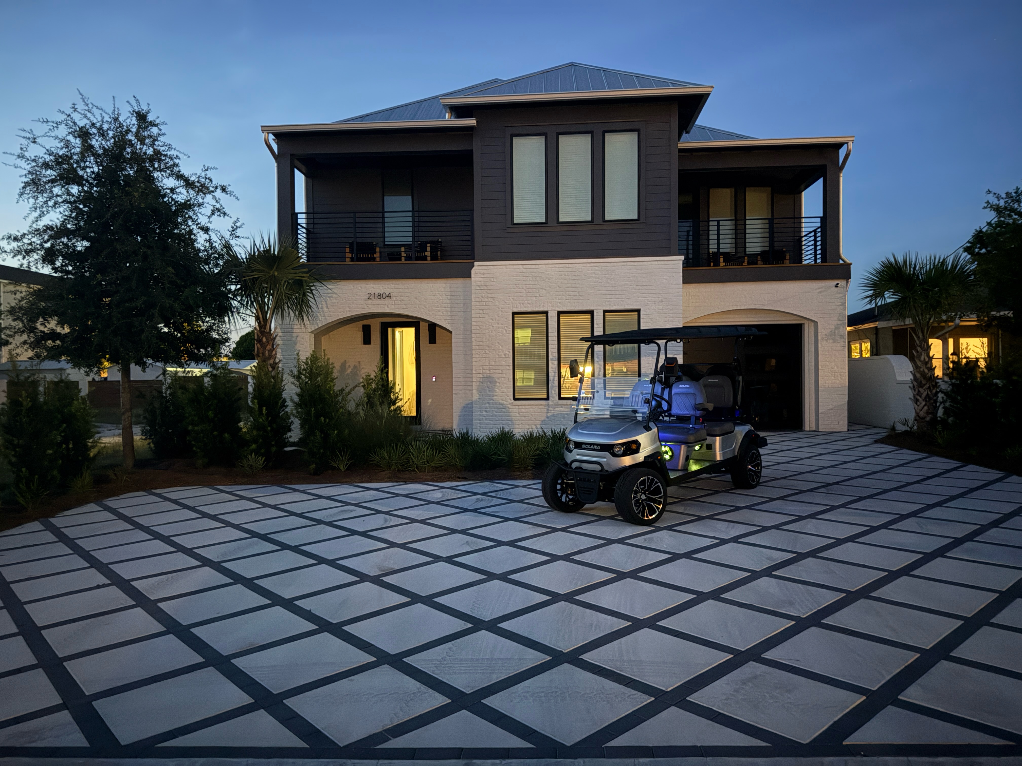 Sunset Belle exterior with balconies, driveway and golf cart