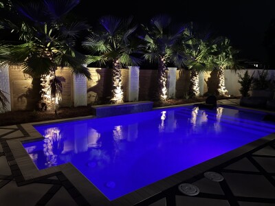 Private pool lit up at night
